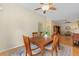 Warm dining area featuring a wooden table, patterned rug, and open floor plan at 762 Turbeville Ter, The Villages, FL 32162