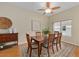 Cozy dining room featuring a wooden table, area rug, and lots of natural light at 762 Turbeville Ter, The Villages, FL 32162