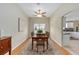Inviting dining room with a wooden table, patterned rug, and views into the kitchen at 762 Turbeville Ter, The Villages, FL 32162