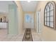 Bright foyer showcasing tile floors, neutral walls, and an elegant entrance door at 762 Turbeville Ter, The Villages, FL 32162