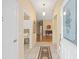 Inviting foyer featuring tile flooring, decorative rug, and views into the living spaces at 762 Turbeville Ter, The Villages, FL 32162