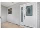 Close-up of the elegant white front door with decorative glass and a sidelight at 762 Turbeville Ter, The Villages, FL 32162
