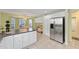 Bright kitchen featuring white cabinets, stainless steel refrigerator, and breakfast nook with bay window at 762 Turbeville Ter, The Villages, FL 32162
