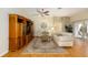 Bright living room featuring hardwood floors, a ceiling fan, and sliding glass doors to the patio at 762 Turbeville Ter, The Villages, FL 32162