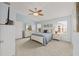 Spacious main bedroom boasts light blue walls, vaulted ceiling, and neutral carpet at 762 Turbeville Ter, The Villages, FL 32162