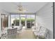Enclosed sunroom featuring a ceiling fan, dining area, and sliding doors to the exterior at 762 Turbeville Ter, The Villages, FL 32162
