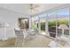 Relaxing sunroom with ceiling fan, comfortable seating, and sliding doors to enjoy the outdoors at 762 Turbeville Ter, The Villages, FL 32162