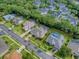 Aerial view of a home with screened-in pool, complemented by lush landscaping and mature trees at 812 Eagle Claw Ct, Lake Mary, FL 32746