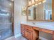 Bathroom featuring a vanity with a large mirror, a glass-enclosed shower, and neutral tile flooring at 812 Eagle Claw Ct, Lake Mary, FL 32746