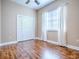 Cozy bedroom featuring wood-look flooring, closet, ceiling fan, and natural light from the window at 812 Eagle Claw Ct, Lake Mary, FL 32746