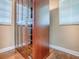 Custom cabinet display with glass doors, wood floors, and natural light from the window at 812 Eagle Claw Ct, Lake Mary, FL 32746