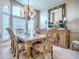Formal dining room with a large window, chandelier and stylish furniture at 812 Eagle Claw Ct, Lake Mary, FL 32746
