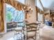 Cozy dining room with chandelier and view of screened outdoor living space at 812 Eagle Claw Ct, Lake Mary, FL 32746