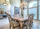 Elegant dining room with a large window, chandelier and stylish furniture at 812 Eagle Claw Ct, Lake Mary, FL 32746
