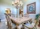 Formal dining room with a large window, chandelier and stylish furniture at 812 Eagle Claw Ct, Lake Mary, FL 32746