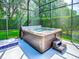 The screened-in hot tub, adjacent to the pool, invites relaxation and adds a touch of luxury to the outdoor space at 812 Eagle Claw Ct, Lake Mary, FL 32746