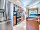 Spacious kitchen with island, wood cabinets, and stainless steel refrigerator at 812 Eagle Claw Ct, Lake Mary, FL 32746