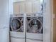Bright laundry room with modern washer and dryer set and ample storage at 812 Eagle Claw Ct, Lake Mary, FL 32746