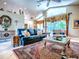 Bright living room with vaulted ceilings, a glass coffee table, and elegant window treatments at 812 Eagle Claw Ct, Lake Mary, FL 32746