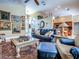 Elegant living room featuring a large leather sofa, decorative rug, and adjacent kitchen at 812 Eagle Claw Ct, Lake Mary, FL 32746
