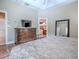 Inviting main bedroom with hardwood floors, a dark dresser, and an ensuite bathroom at 812 Eagle Claw Ct, Lake Mary, FL 32746
