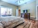 Bright bedroom with hardwood floors, a large dresser, and views of the outdoor patio at 812 Eagle Claw Ct, Lake Mary, FL 32746