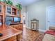 Office space featuring hardwood floors, a desk, a bookcase with TV, and an open doorway to another room at 812 Eagle Claw Ct, Lake Mary, FL 32746