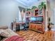 Office space featuring hardwood floors, a desk, a sofa, and a large bookcase with a TV at 812 Eagle Claw Ct, Lake Mary, FL 32746
