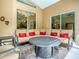 Comfortable screened patio with cozy seating around an elegant fire pit table at 812 Eagle Claw Ct, Lake Mary, FL 32746