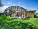 A screened-in pool and patio area with a well-manicured lawn in the backyard at 812 Eagle Claw Ct, Lake Mary, FL 32746