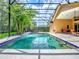 A screened-in pool with a water feature and beautiful landscaping creates an ideal backyard oasis at 812 Eagle Claw Ct, Lake Mary, FL 32746
