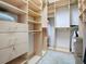 Spacious walk-in closet with custom shelving, drawers, and ample storage space at 812 Eagle Claw Ct, Lake Mary, FL 32746