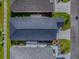 Aerial view of property with a large backyard, mature trees, and lush greenery, outlined in red at 865 Conroe St, The Villages, FL 34762
