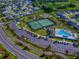 Aerial view showcasing community amenities including a swimming pool and tennis courts at 865 Conroe St, The Villages, FL 34762