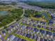 Drone shot of homes surrounded by verdant trees and serene ponds at 865 Conroe St, The Villages, FL 34762