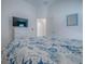 Cozy bedroom showcasing a white dresser with a television and a comfortable bed with ocean-themed bedding at 865 Conroe St, The Villages, FL 34762