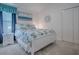 Comfortable bedroom featuring a white bed with ocean-themed blue and white bedding and a coordinating bedside table at 865 Conroe St, The Villages, FL 34762