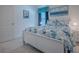 Well-lit bedroom with a white bed dressed in ocean-themed bedding, complemented by matching curtains and wall decor at 865 Conroe St, The Villages, FL 34762