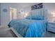 Bright bedroom featuring a comfortable blue bed, matching pillow and soft lighting at 865 Conroe St, The Villages, FL 34762
