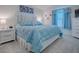 Bright bedroom featuring a comfortable blue bed, white nightstand and dresser for ample storage and relaxation at 865 Conroe St, The Villages, FL 34762