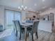 Open-concept dining room with modern lighting and access to the kitchen, creates a spacious and inviting atmosphere at 865 Conroe St, The Villages, FL 34762