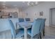 Open-concept dining area connecting to kitchen, featuring modern table set for six, natural light and views at 865 Conroe St, The Villages, FL 34762