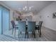 Well-lit dining area adjacent to a modern kitchen, featuring a sleek table set for six and stylish decor at 865 Conroe St, The Villages, FL 34762