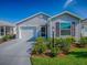 Charming single-story home with gray siding, neat landscaping, and a convenient attached garage at 865 Conroe St, The Villages, FL 34762