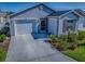 Charming home featuring a two-car garage, a manicured lawn, and tasteful landscaping for curb appeal at 865 Conroe St, The Villages, FL 34762