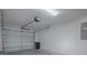 Spacious garage with an automatic door, offering ample storage and parking space, enhanced by bright lighting at 865 Conroe St, The Villages, FL 34762