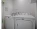 Well-lit laundry room with modern white Maytag washer and dryer, offering convenience and efficiency at 865 Conroe St, The Villages, FL 34762
