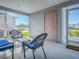 Enclosed patio features cozy wicker furniture, offering a comfortable space for outdoor relaxation and enjoyment at 865 Conroe St, The Villages, FL 34762