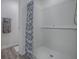 Modern bathroom walk-in shower featuring white subway tiles and a stylish blue floral shower curtain at 865 Conroe St, The Villages, FL 34762