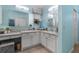 Bright bathroom featuring double sinks, white cabinets and drawers for ample storage at 8980 Se 176Th Limerick Ln, The Villages, FL 32162